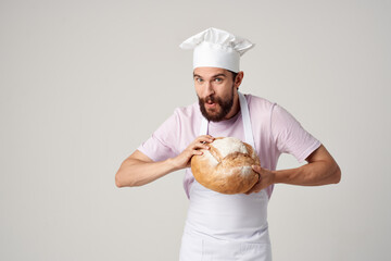 male chef with bread in his hands cooking baking