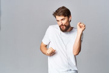 Cheerful man gesturing with his hands in a white t-shirt casual wear dance