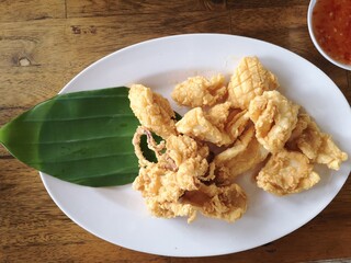 Fried squid in a white plate.