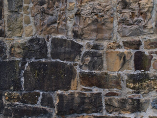 Closeup view of historic stone wall of old medieval fortress in Esslingen, Baden-Württemberg, Germany with beige and grey colored pattern.