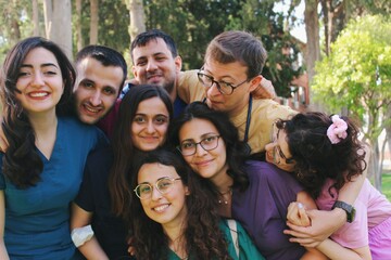 Team  portrait of healthcare worker friends / intern doctors / medical students together & smiling happy
