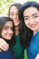 Team  portrait of healthcare worker friends / intern doctors / medical student women together & smiling happy
