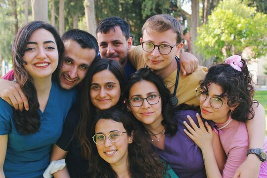 Team  portrait of healthcare worker friends / intern doctors / medical students together & smiling happy *2