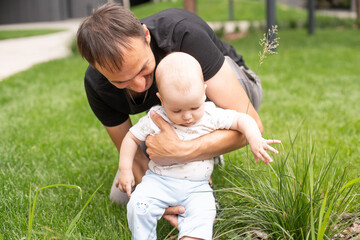 Summer portrait of beautiful baby on the lawn