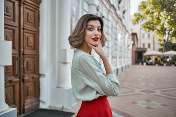 Fototapeta premium woman outdoors near building red lips walk