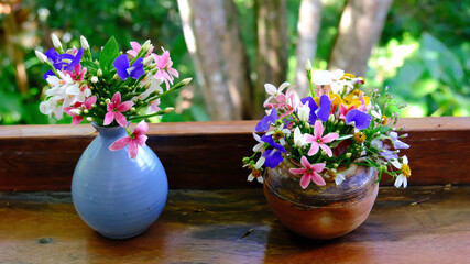 Bouquet of colorful flowers arranged in small vase, selective focus.