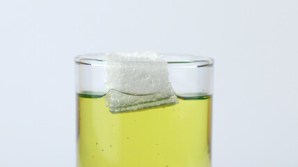 Styrofoam floats on olive oil, demonstration of density experiment with liquid. The science concept...