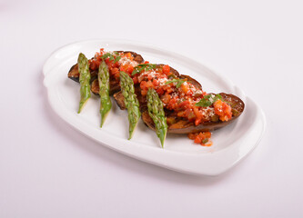 baked bbq eggplant with chef homemade salsa sauce and asparagus in white background for Christmas festival menu
