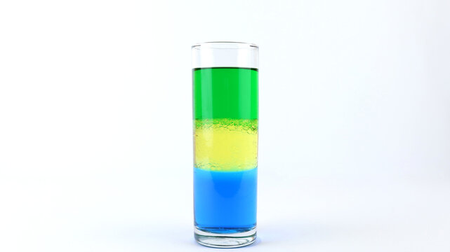Liquid or layer density experiment using 3 separate layers consisting of water, olive oil and alcohol on the top layer on the glass. The science concept of density
