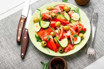 Salad with vegetables, olives, eggs and rosemary
