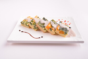 steamed egg pudding with pumpkin and vegetables with white coconut sauce in white background for Christmas festival menu