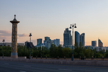 View from ”Maral” bridge at the left bank of the city Nur-Sultan, Kazakhstan. Sunset time.