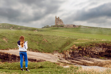 Young girl and a castle in the background