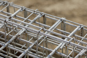 Shallow depth of field (selective focus) image with steel used for reinforcing concrete, on a construction site.