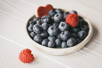 blueberries in a small ceramic bowl with a red heart decor