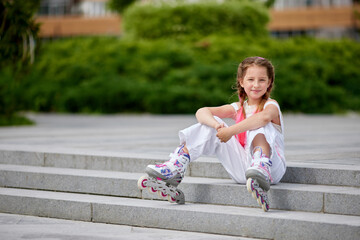 cute little girl on roller skates at park.