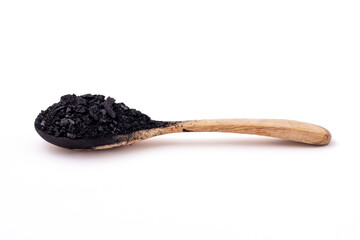 Side view of Small pieces and powder of charcoal was placed on a wooden spoon isolated on a white background.