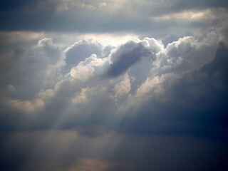 Clouds, storm clouds and sunbeams before heavy rain.