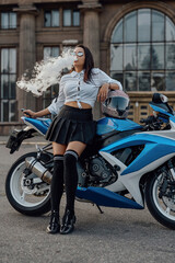 Fototapeta na wymiar Woman dressed like schoolgirl posing with motorcycle outside