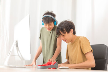 Teenage Couple with headphone play game online At Home Computer.