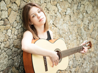 Fototapeta na wymiar Teenage girl with a guitar
