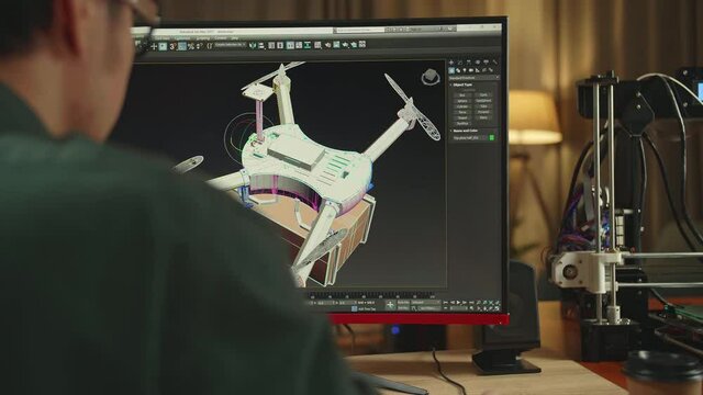 Over The Shoulder Asian Engineer Working On Personal Computer And 3D Printer, Screen Shows Cad Software With 3D Prototype Of Drone Delivery
