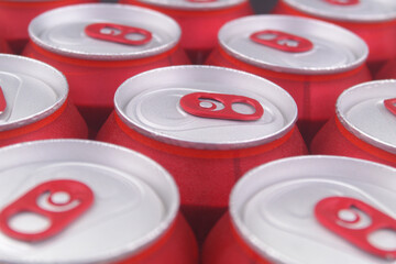 Many red closed tin cans close-up