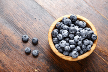 Fresh blueberries in a wooden bowl