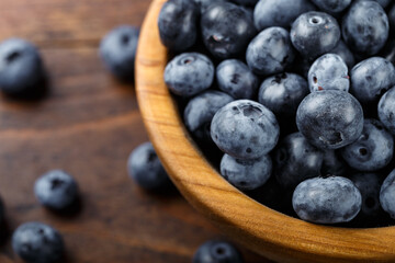 Freshly picked blueberries in a wooden bowl. Healthy berry, organic food, antioxidant, vitamin