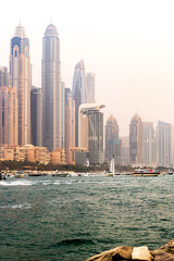 Fototapeta na wymiar Dubai, UAE - 07.30.2021 - People enjoying day off in Dubai Marina. Outdoors