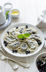Blueberry dumplings on a white plate. Traditional home dish