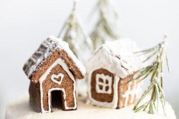 two gingerbread houses on white background, christmas card, selective focus