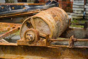 A rusty conveyor belt pulley from an old crusher