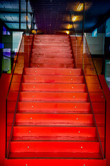 Red staircase with glass railing
