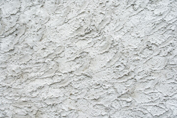 The texture of a gray plastered wall with pronounced stucco. Flat lay of the frame. Template for the designer