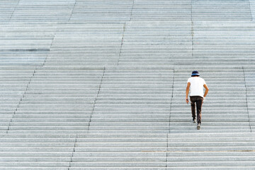 A man climbs the granite steps of the city staircase. Copy space