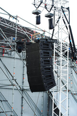 Audio speakers at the concert venue. Musical equipment for public events and information broadcast. Vertical photo. Close-up
