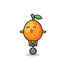 The cute kumquat character is riding a circus bike
