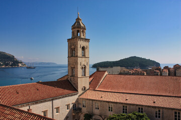 Fototapeta na wymiar View to the Dubrovnik harbor with a church and a sailing boat in the background, Dalmatia region of Croatia