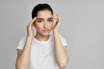 woman in white t-shirt headache problems negative