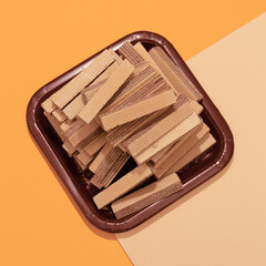 Waffle and plastic plate flat lay scene. Minimal  food art fashion. Sweet lover, candy shop, calorie, diet concept