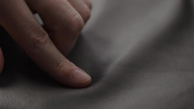 Slide shot man touching fine leather closeup