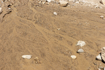 Boulders, pebbles and wet sand of the dry river © kelifamily