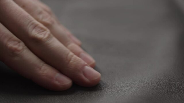 Slide shot man touching fine leather closeup