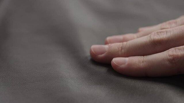 Slide shot man touching fine leather closeup