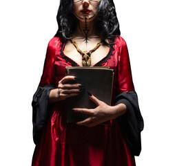 Isolated witch or sorceress with runic makeup and wooden animal skull amulet holding a magic book. Halloween concept.