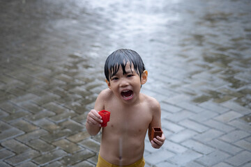 
Asian little kids having fun in the rain