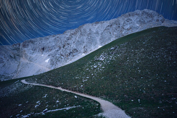 path in the meadow that leads to the great horn of abruzzo long exposure stars
