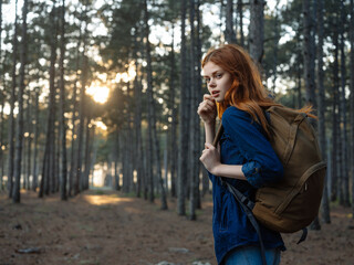 pretty woman in forest backpack nature walk lifestyle