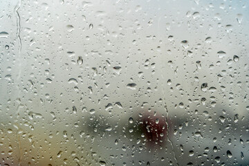 Raindrops on the window. Drops of condensation water and wet on the glass background. Rainy cloudy weather, sad mood concept.